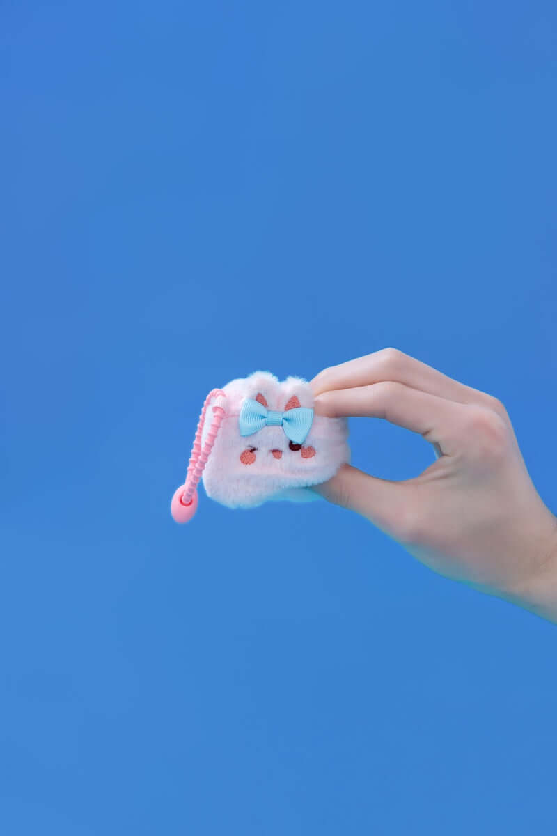 Mini Rabbit | Squishy Emotional Collectible Plush Toys in hand, featuring soft materials and clip-on strap.